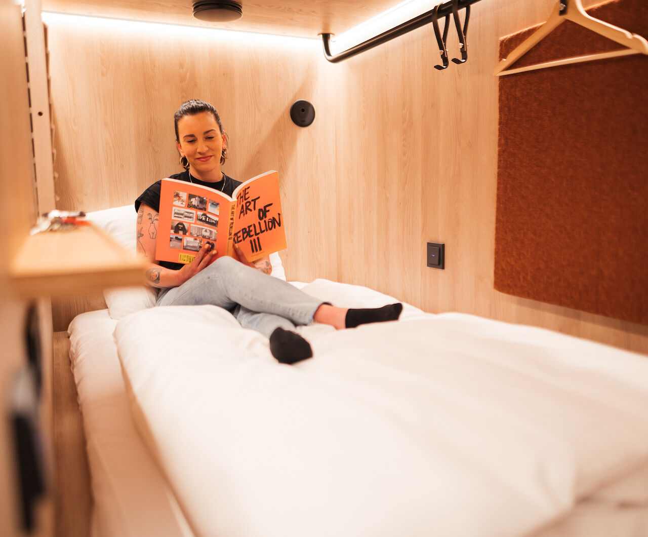 woman reading in book in bed in hostel hamburg - hotel hamburg cheap - booking hotel in hamburg - CAB20